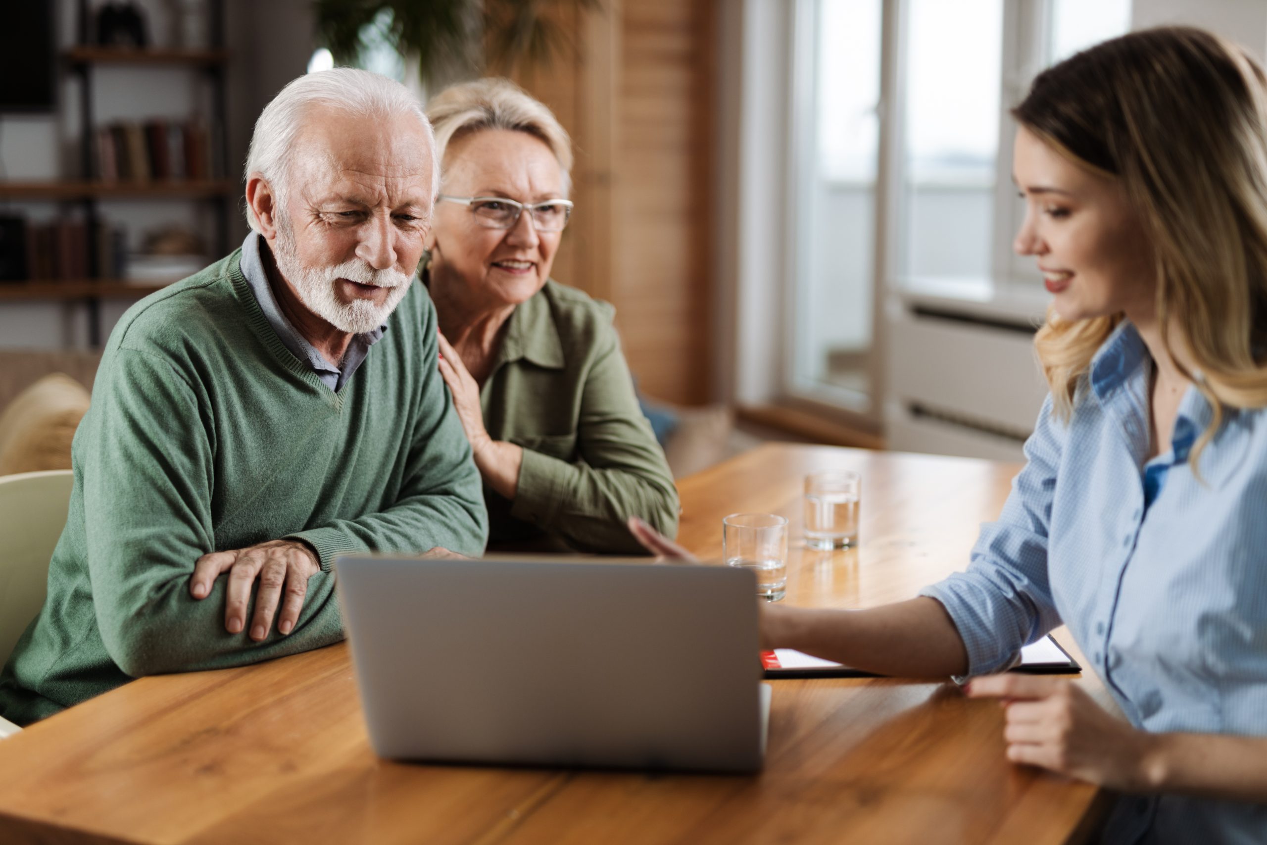 Elderly couple engaging with a young woman.