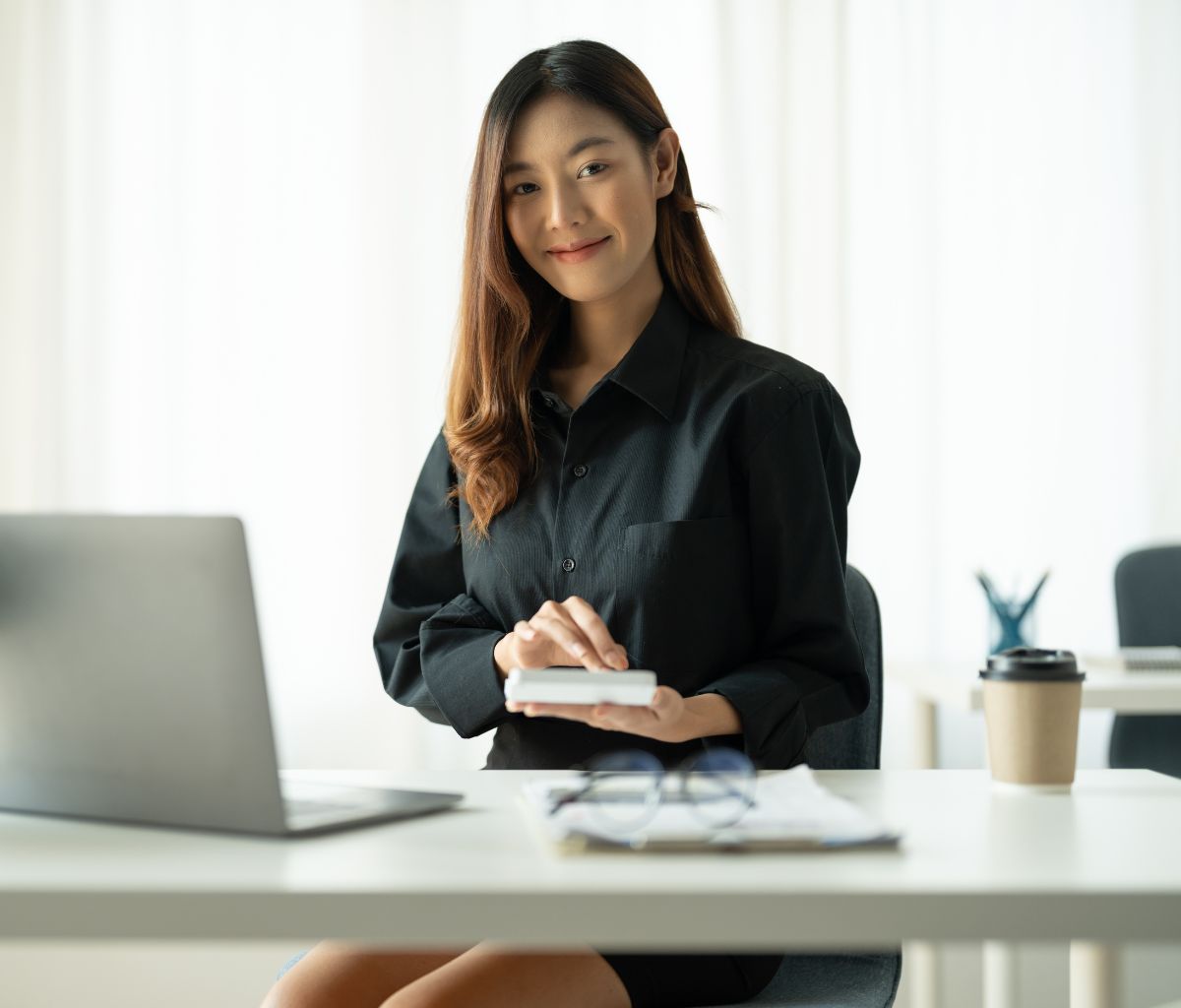 Woman smiling while working at desk.