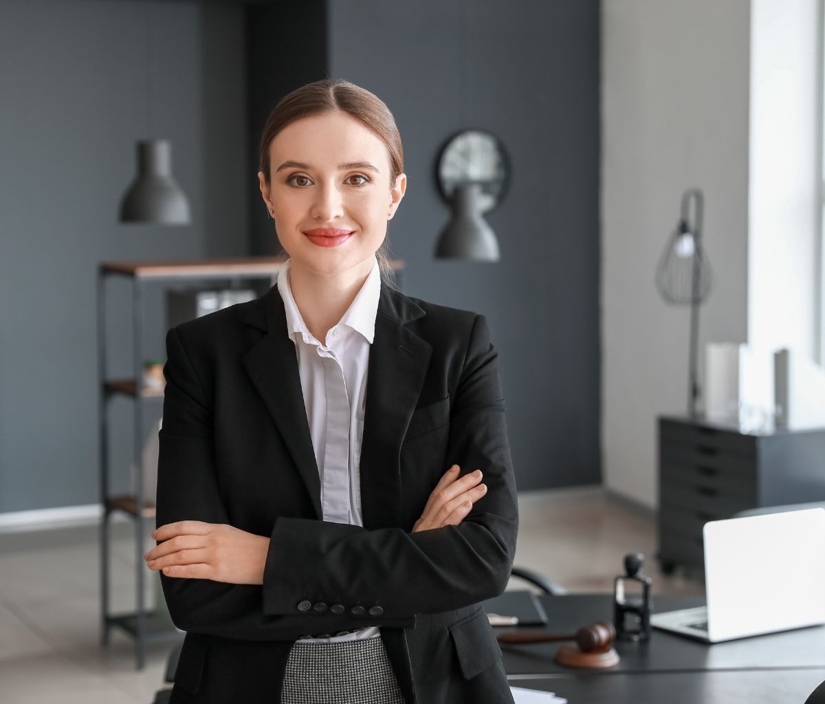 Businesswoman smiling in modern office setting.